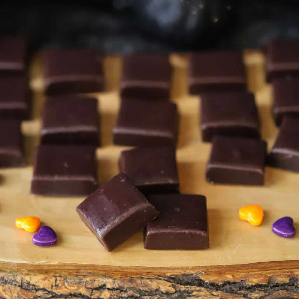 black licorice caramel candies on a serving tray