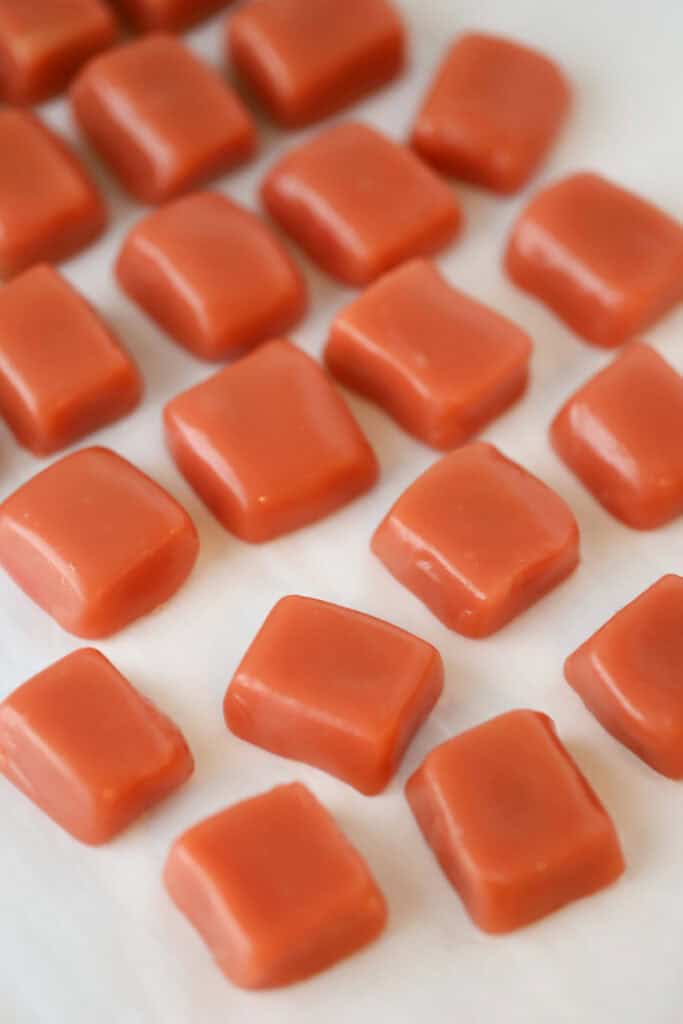 A tray full of cinnamon caramel candy cut into small squares.