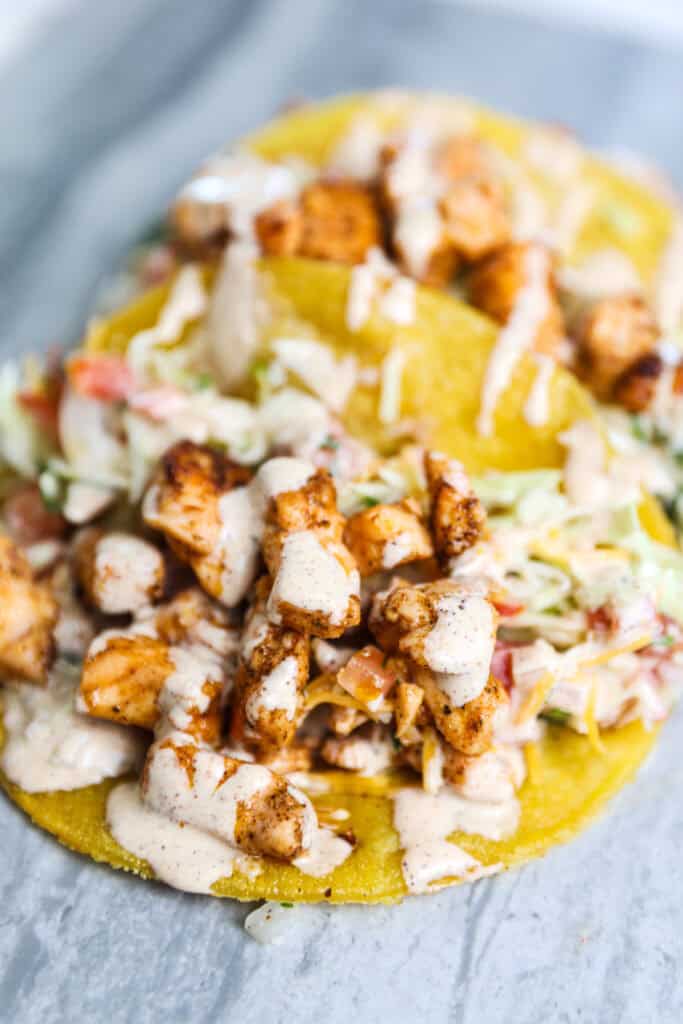A blackened salmon taco opened to show all of the ingredients.