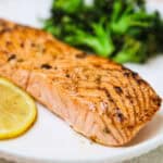 lemon garlic salmon recipe on a white plate and broccoli