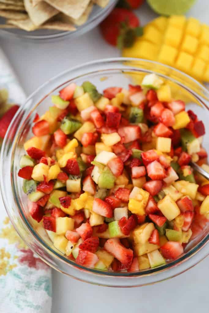 A bowl full of this fruit salsa recipe with strawberries, kiwi, pineapples, and mangos.