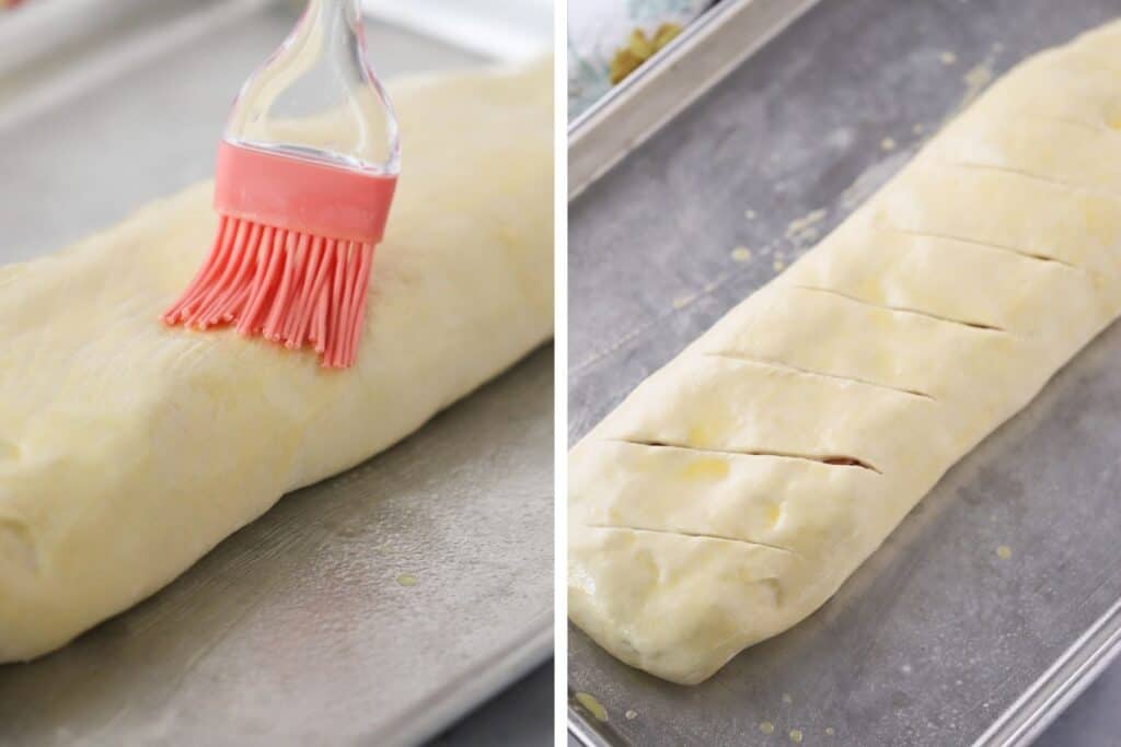 Brushing egg wash over the top of stromboli dough.