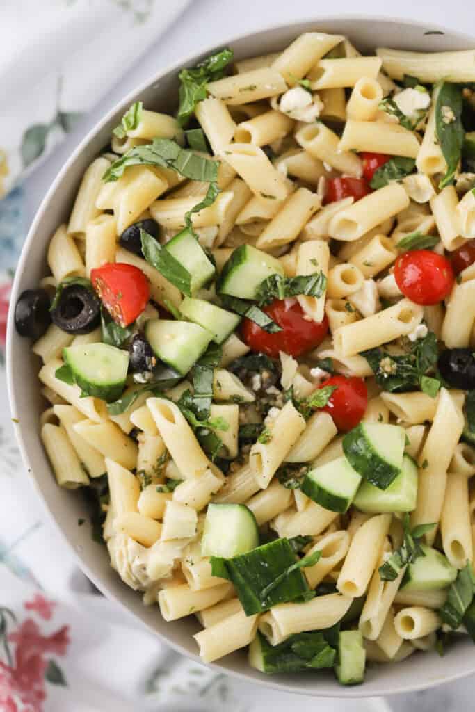 A big serving bowl full of Greek Pasta Salad.