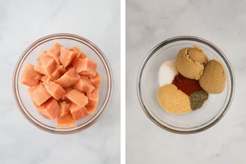 Fresh salmon cut into pieces with spice rub ingredients in a small bowl.