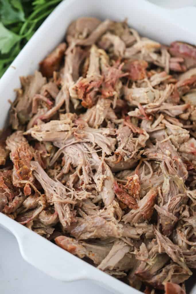 A baking dish full of smoked pulled pork.