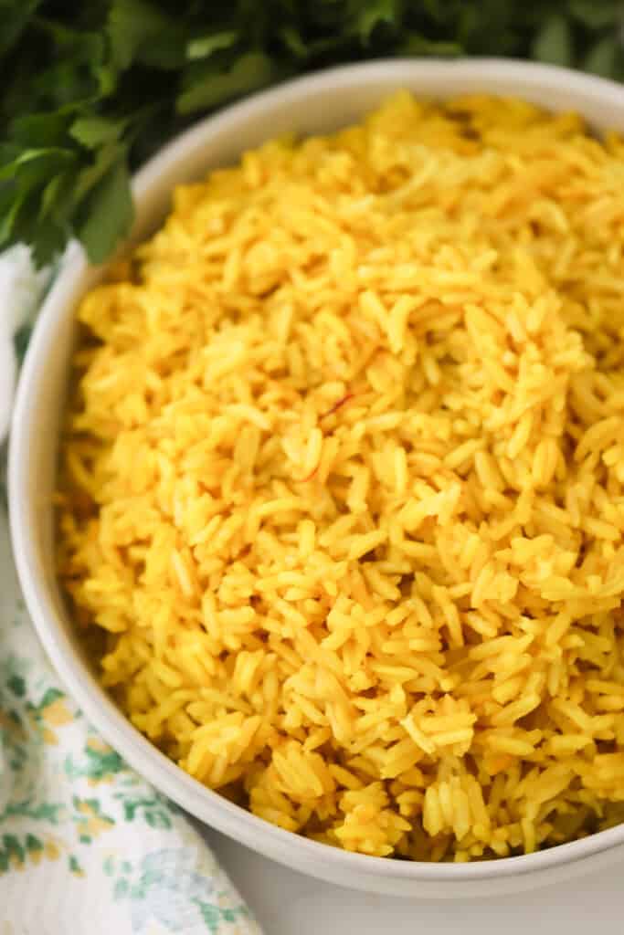 A large bowl full of yellow rice.