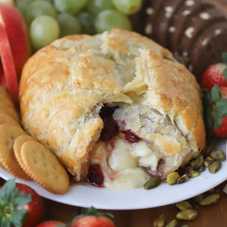 Cranberry and Brie Puff Pastry on a plate with dippers.