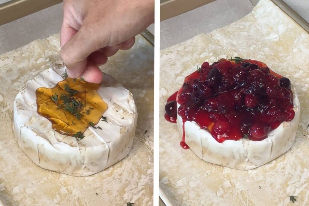 A hand sprinkling chopped thyme over honey and brie cheese, then adding cranberry sauce over the very top.