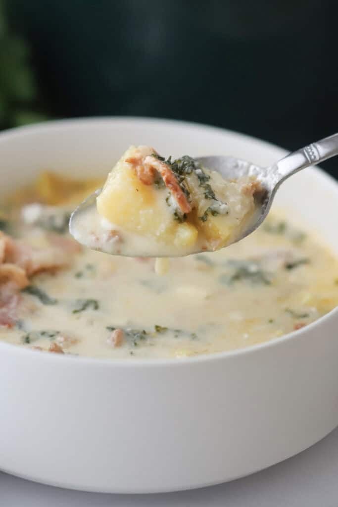 A big bowl of copycat Olive Garden Zuppa Toscana with a spoon.