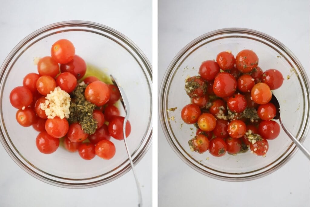 A glass bowl with cherry tomatoes, garlic, and pesto.