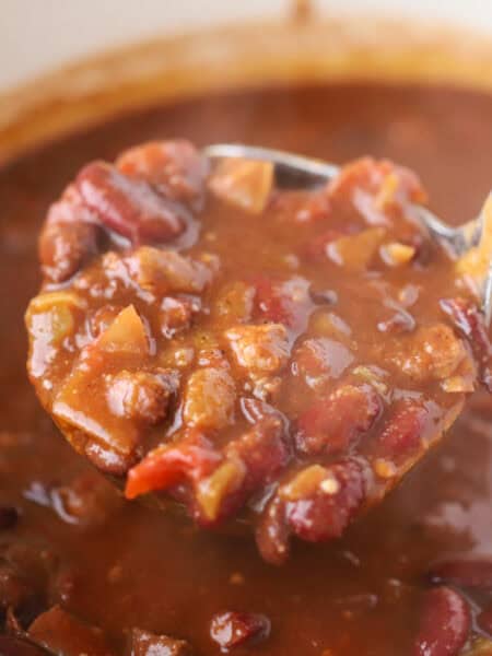 how to make brisket chili, a big ladle of chili with brisket.
