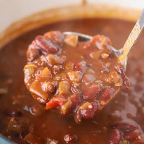 how to make brisket chili, a big ladle of chili with brisket.