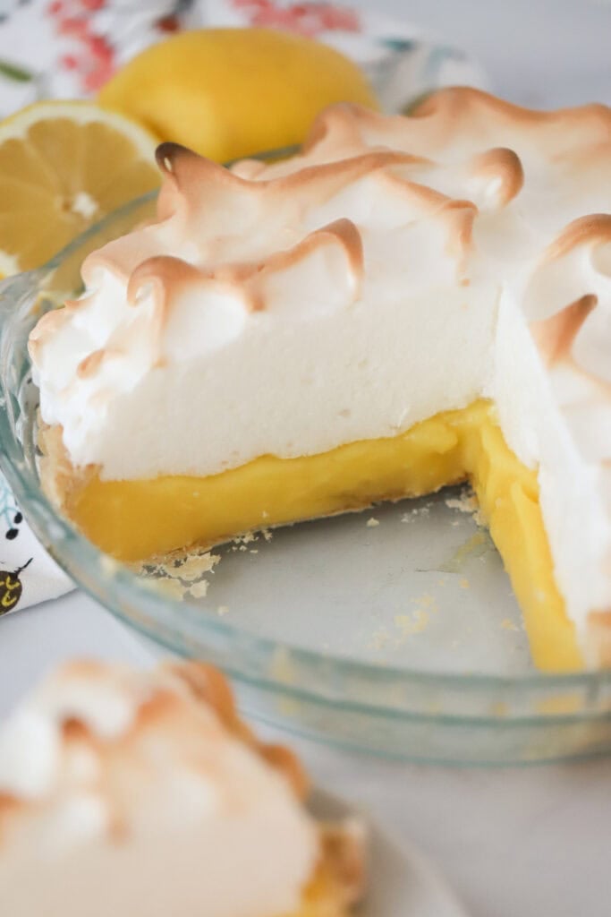 A lemon meringue pie with a slice removed.