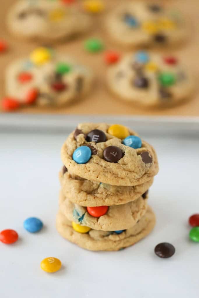 A stack of peanut butter cookies with M&Ms.