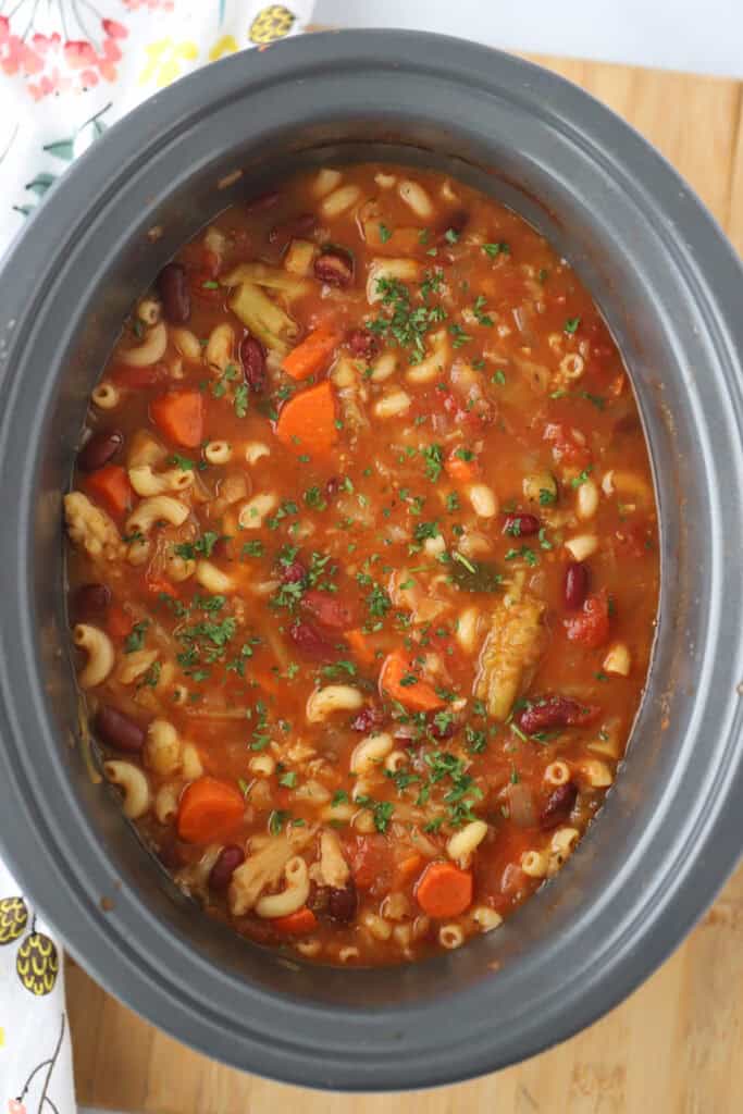 A crockpot full of hearty Italian minestrone soup.