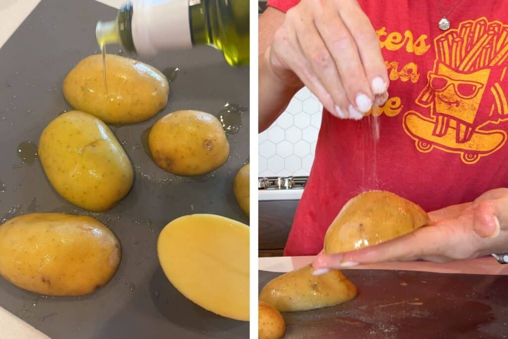 A hand seasoning the potato halves with salt.