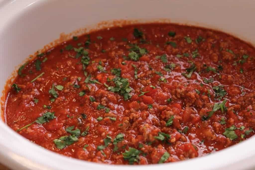 A slow cooker full of slow cooker spaghetti sauce.
